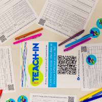 Teach-In survey papers with pens and stickers around